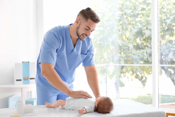 Pediatrician checking on baby.